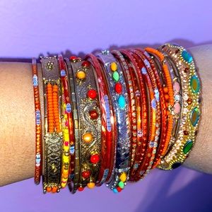 Stack of 28 bangles—warm colors